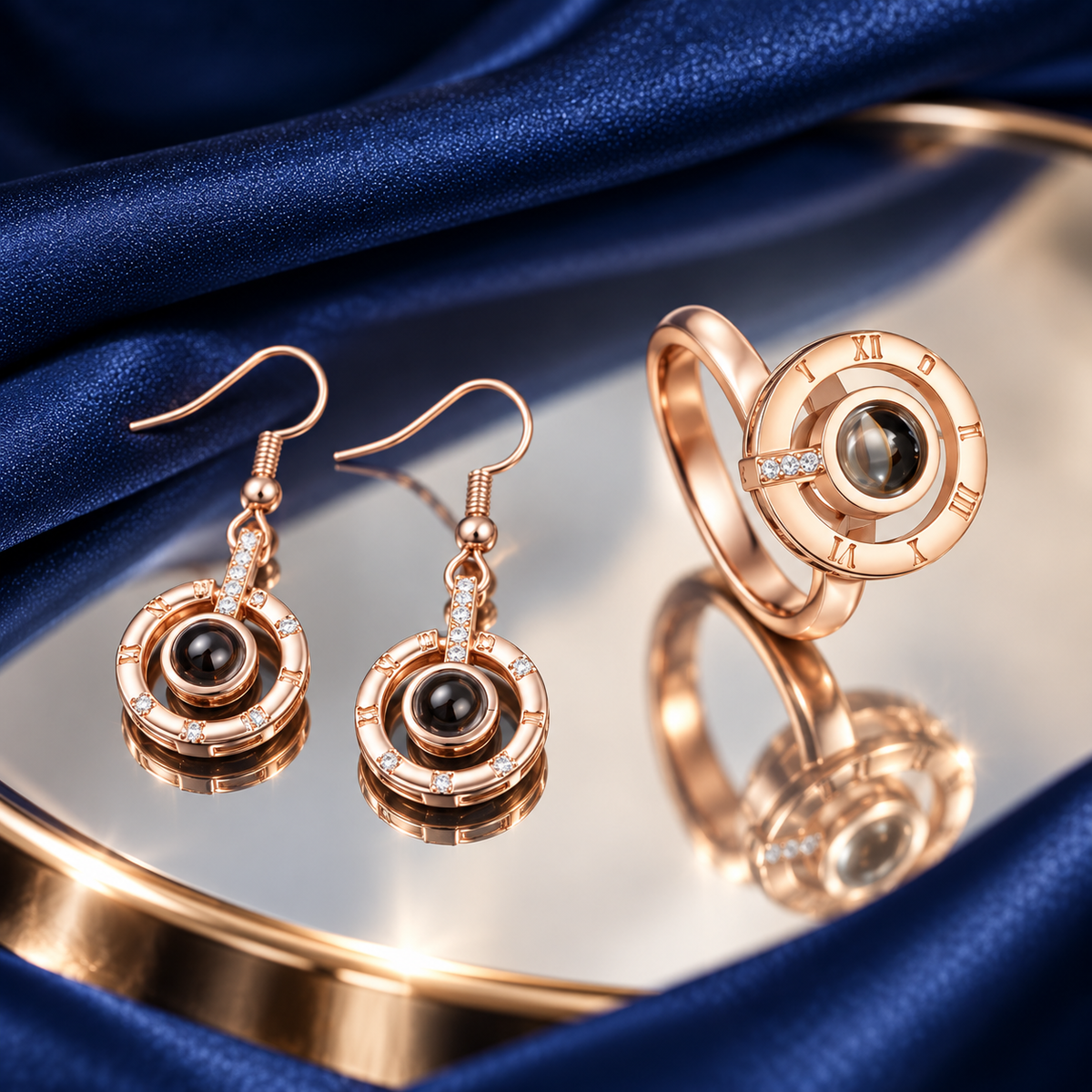 Schmuckset Römische Ziffern in Roségold: Ohrhänger und Fotoring auf Spiegelglas und dunkelblauem Satin