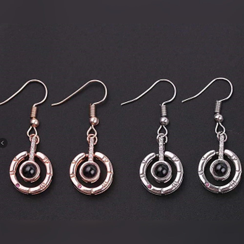 Ohrhänger mit Kreis, römischen Ziffern und Fotolinse in Roségold und Silber
